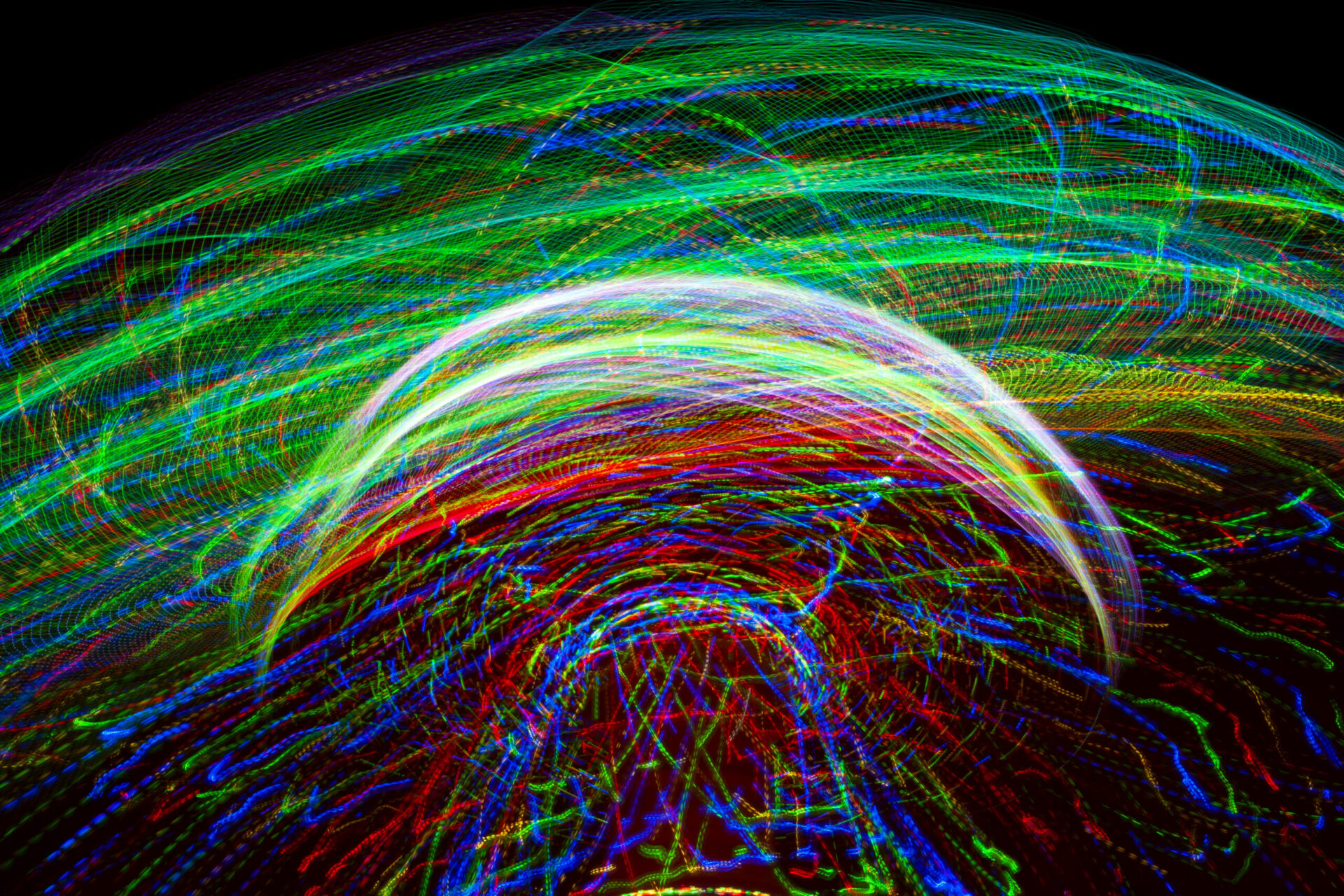 Carnival amusement park ride with swings. Spinning fair ride at night with bright purple, red, green and yellow lights.
