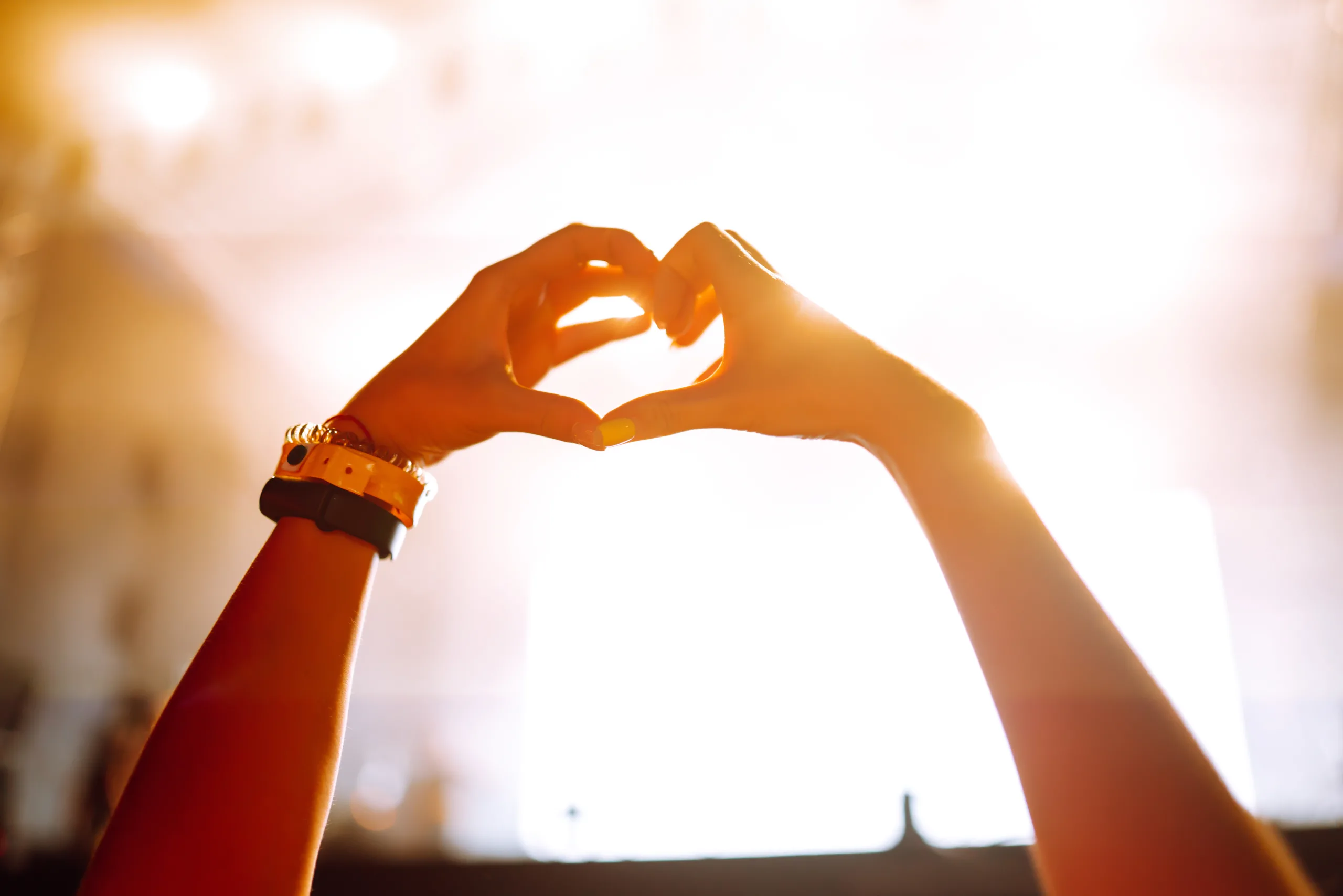 Heart shaped hands at concert, loving artist and festival. Music concert with lights the concert.