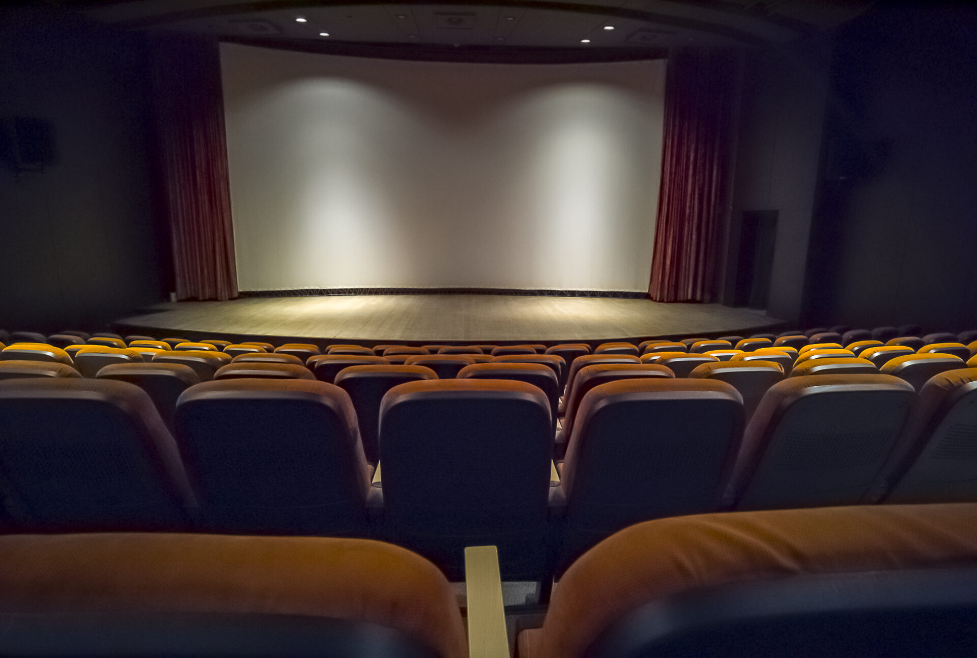 Empty chairs in the stands of the movie theater. Many empty seats for spectators.