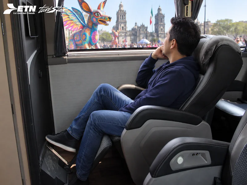 Interiores de autobús ETN Turistar con asientos reclinables de piel, pantallas táctiles individuales y módulos de sanitarios independientes